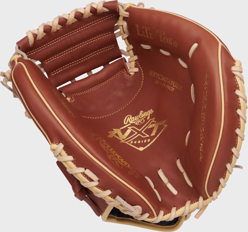 Dark brown palm of a Rawlings NXT Series catcher's mitt with gold stamping and tan laces loading=
