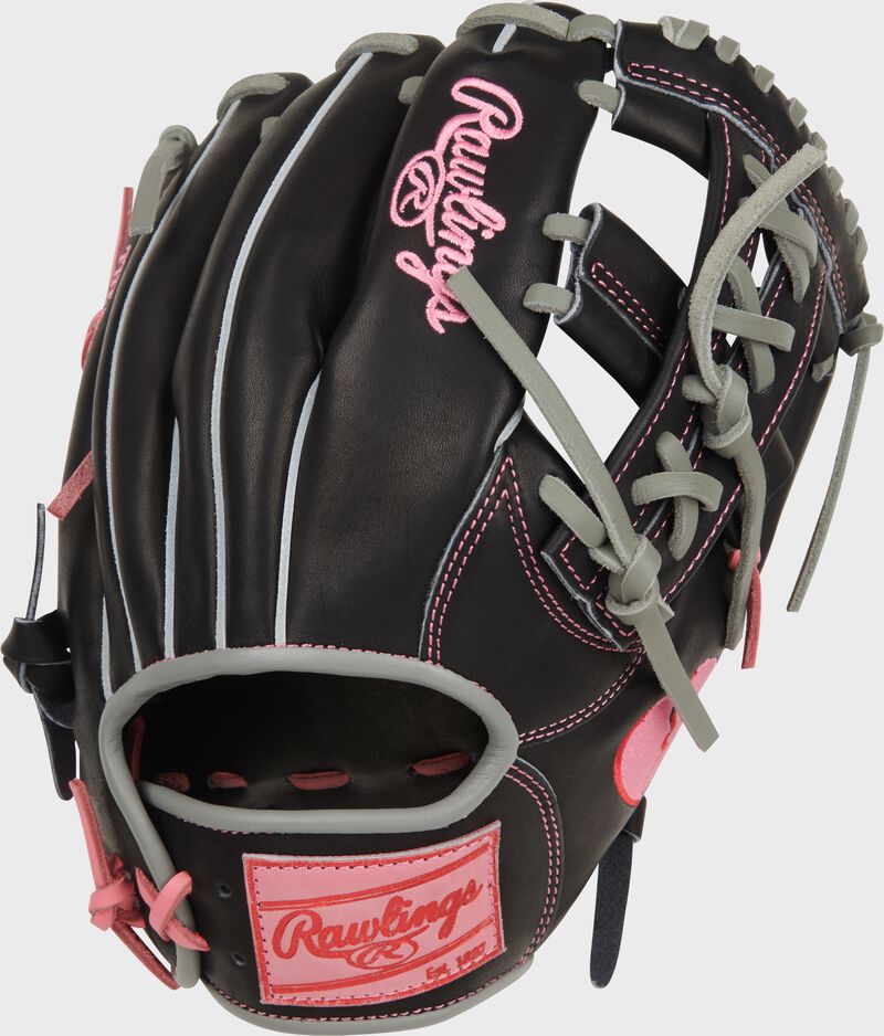 Back of a black Rawlings Heart of the Hide Broken Heart 11.5" glove with a pink Rawlings patch loading=