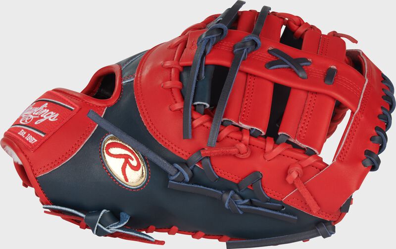 Thumb of a navy/scarlet Gameday 57 Series Vladimir Guerrero Pro Preferred 1st base mitt with a gold Oval-R on the thumb loading=