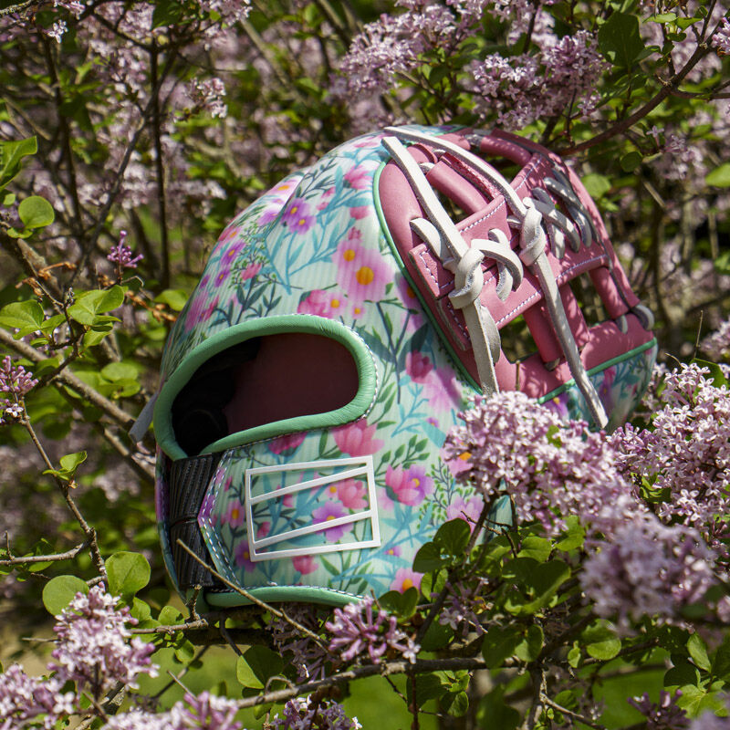 Picture of the back of a Rawlings Race Day REV1X infield glove in a flower bush loading=