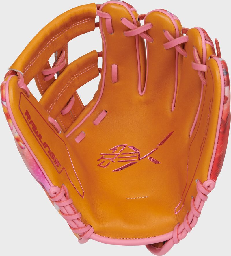 Tan palm of a Rawlings Francisco Lindor REV1X glove with pink laces loading=