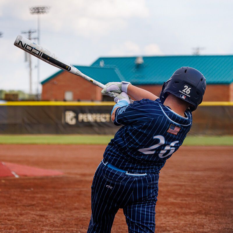 Picture from behind of a player hitting a ball with a 2025 Icon USSSA bat loading=