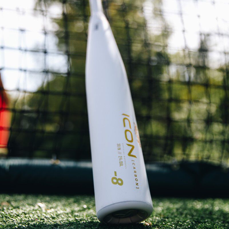 White barrel of a 2024 Icon USSSA baseball bat in a batting cage - SKU: RUT4I loading=
